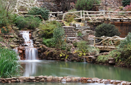 A Bride and Groom holding hands at Bellingrath Gardens.