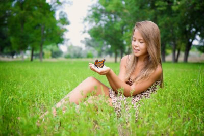 A young girl releasing a monarch butterfly in rural North Carolina